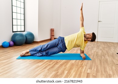 Young Arab Sporty Man Concentrate Training Yoga At Sport Center.