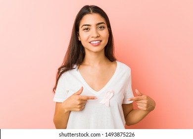 Young arab woman with a pink bow. Concept of fight against cancer. - Shutterstock ID 1493875226