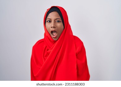 Young arab woman wearing traditional islamic hijab scarf angry and mad screaming frustrated and furious, shouting with anger. rage and aggressive concept.  - Shutterstock ID 2311188303