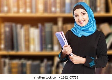 Young arabian female student in library