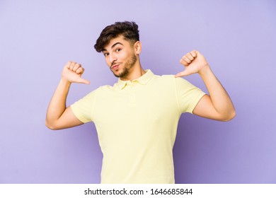 Young arabian man isolated on a purple background feels proud and self confident, example to follow. - Shutterstock ID 1646685844