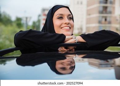 Young Arabian Woman Standing Next To Car - Powered by Shutterstock