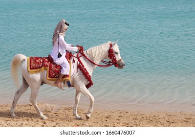 A Young Arabic Boy Riding A White Horse At Katara Beach - Doha, Qatar - 02/22/2020