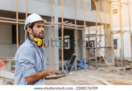 Young architect engineering consultant using laptop on construction site inspecting the building, inspecting, designing, and planning Project Manager at Middle East Workers Success