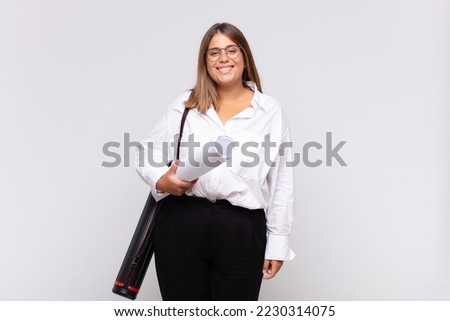 young architect woman looking happy and pleasantly surprised, excited with a fascinated and shocked expression