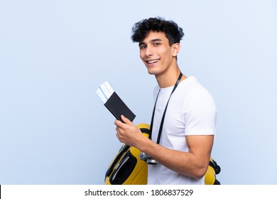 Young Argentinian Traveller Man Over Isolated Blue Background