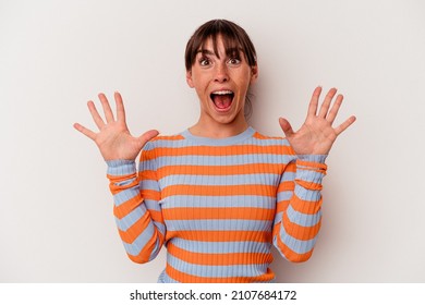 Young Argentinian woman isolated on white background receiving a pleasant surprise, excited and raising hands.