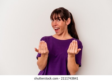 Young Argentinian woman isolated on white background pointing with finger at you as if inviting come closer.