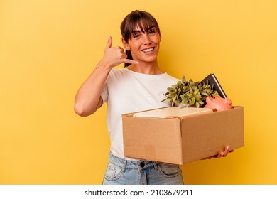 Young Argentinian woman making a move isolated on yellow background Young Argentinian woman making a move isolated on yellow background showing a mobile phone call gesture with fingers.