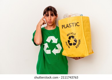 Young Argentinian woman recycled plastic isolated on white background pointing temple with finger, thinking, focused on a task.