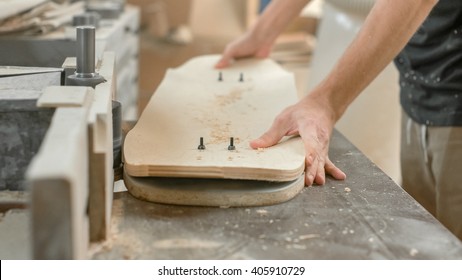 Young artisan man cutting maple wood - Powered by Shutterstock