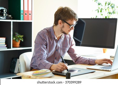 Young Artist Drawing Something On Graphic Tablet At The Home Office