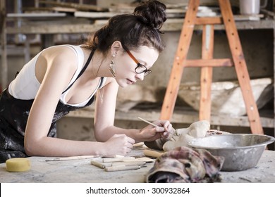 Young Artist Moulding Raw Clay In Art Studio