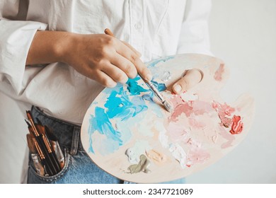 Young artist with painting brushes and colors. Craft artistic background. Recomforting, destressing creative hobby, art therapy - Powered by Shutterstock