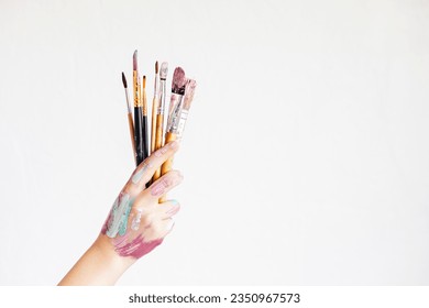 Young artist with painting brushes and colors. Craft artistic background. Recomforting, destressing creative hobby, art therapy - Powered by Shutterstock