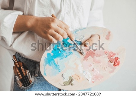 Young artist with painting brushes and colors. Craft artistic background. Recomforting, destressing creative hobby, art therapy