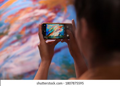 Young artist taking photo of masterpiece painting in art workshop. Modern artwork paint on canvas, creative, contemporary and successful fine art artist drawing masterpiece - Powered by Shutterstock