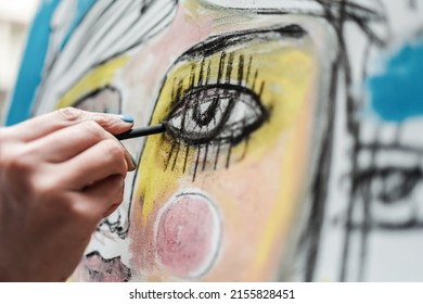 Young Artist Woman Painting On Canvas At Her Home Studio - Focus On Finger Holding Charcoal