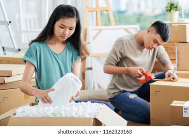 Young Asain Couple Getting Ready To Move Out