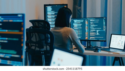 Young Asia female freelance eyeglasses typing write prompt AI bot IT app smart program nomad, video game, terminal with coding language, designer, big data center on desktop computer in night office.
