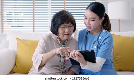 Young Asia Female Nurse, Assisted Living, In-home Carer Or Doctor Visit Old Senior Citizen At Home Talk About Result Follow Up Checklist, Health Care Advice Or Prescription Online On Tablet Computer.