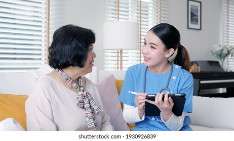 Young Asia Female Nurse, Assisted Living, In-home Carer Or Doctor Visit Old Senior Citizen At Home Talk About Result Follow Up Checklist, Health Care Advice Or Prescription Online On Tablet Computer.