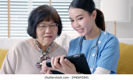 Young Asia Female Nurse, Assisted Living, In-home Carer Or Doctor Visit Old Senior Citizen At Home Talk About Result Follow Up Checklist, Health Care Advice Or Prescription Online On Tablet Computer.