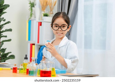 A young Asia girl scientist in a white lab coat conducting an experiment with a microscope in a modern laboratory setting. - Powered by Shutterstock