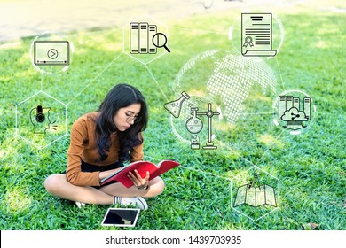 A Young Asia Girl Is Thinking And Learning Outside A School In Park, Education About Internet Of Thing Is Study Everywhere Concept. Technology And Educate Icon Background With Effect Filter.