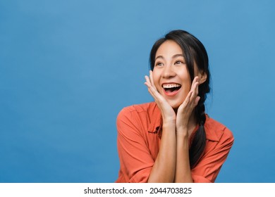 Young Asia lady feel happiness with positive expression, joyful surprise funky, dressed in casual cloth isolated on blue background. Happy adorable glad woman rejoices success. Facial expression. - Shutterstock ID 2044703825