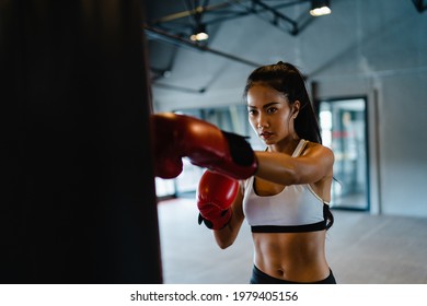 Young Asia Lady Kickboxing Exercise Workout Punching Bag Tough Female Fighter Practice Boxing In Gym Fitness Class. Sportswoman Recreational Activity, Functional Training, Healthy Lifestyle Concept.