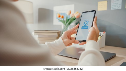 Young asia lady use cellphone order online shopping product and paying bills with banking app with transaction successful. Stay at house, Quarantine activity, Fun activity for coronavirus prevention. - Shutterstock ID 2025363782