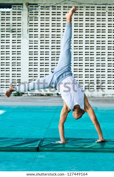Young asia man stretching muscles for\
flexibility is the basis of\
gymnastic