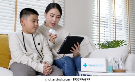 Young Asia Parents And Son Talk To Doctor On Cellphone Videocall Conference Medical App In Pediatric Care Online Telehealth Telemedicine Online Service Hospital Quarantine Social Distance At Home.