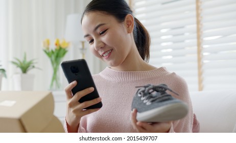 Young Asia People Happy Teen Girl Smile Unbox Open Gift New Shoe Buy Order From Online Store Shop Take Photo Shoot Camera Show Post Social Media App Blog Vlog Share Sit Relax At Home Sofa Couch.