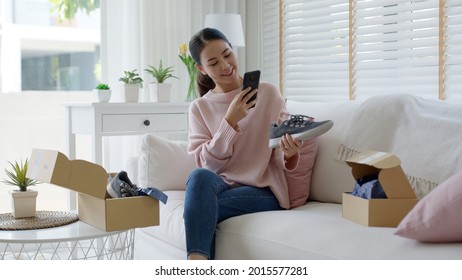 Young Asia People Happy Teen Girl Smile Unbox Open Gift New Shoe Buy Order From Online Store Shop Take Photo Shoot Camera Show Post Social Media App Blog Vlog Share Sit Relax At Home Sofa Couch.