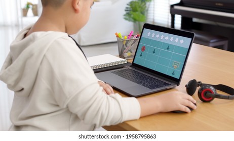 Young asia student kid remotely learn online at home in unplugged coding in STEM, STEAM, algorithms logical mathematics engineering science technology computer code in robotics for kids concept.