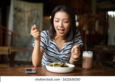 Young Asia Woman Eating Spaghetti At Restaurant