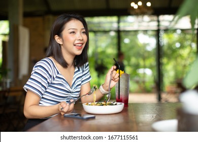 Young Asia woman eating spaghetti at restaurant