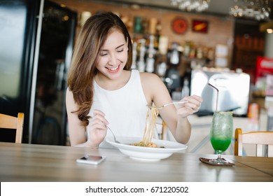 Young Asia Woman Eating Spaghetti At Restaurant