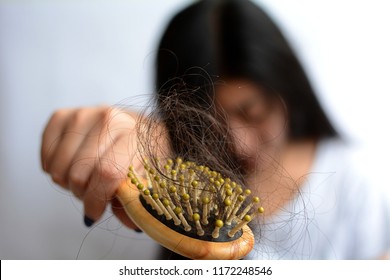 Young asia woman having serious hair loss, hair fall everyday serious problem.