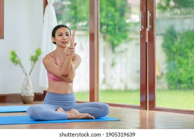 Young Asia Woman Practicing Yoga In Living Room