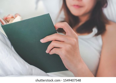 Young Asia Woman Reading Book On Bed At Her Hoom, Selective Focus.