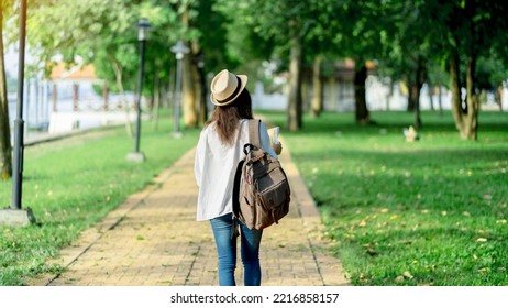 Young Asia Woman Traveler With Backpack Checks Map To Find Directions In Temple Area, Real Explorer. Travel Concept