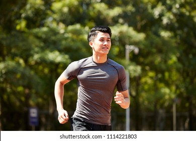 Young Asian Adult Man Athlete Running And Training.