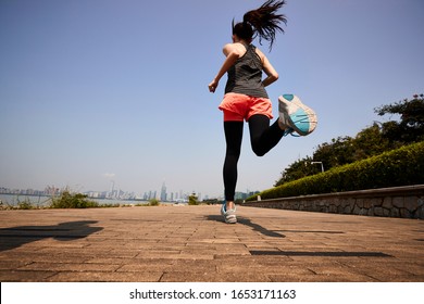 Young Asian Adult Woman Running Jogging Outdoors, Rear And Low Angle View