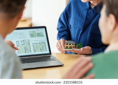 young asian architect explaining house plan to senior asian couple - Powered by Shutterstock