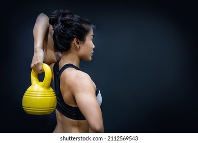 Young Asian Athlete Woman Doing Exercise With Kettlebell In Fitness Gym. Strength Training Class