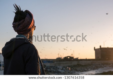 Similar – Image, Stock Photo Young woman with pipe backlit by the sea in the midnight sun