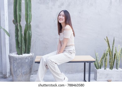 Young Asian beautiful and pretty woman wearing open shoulder dress, off the shoulder or cutout dress with smile and happy emotion